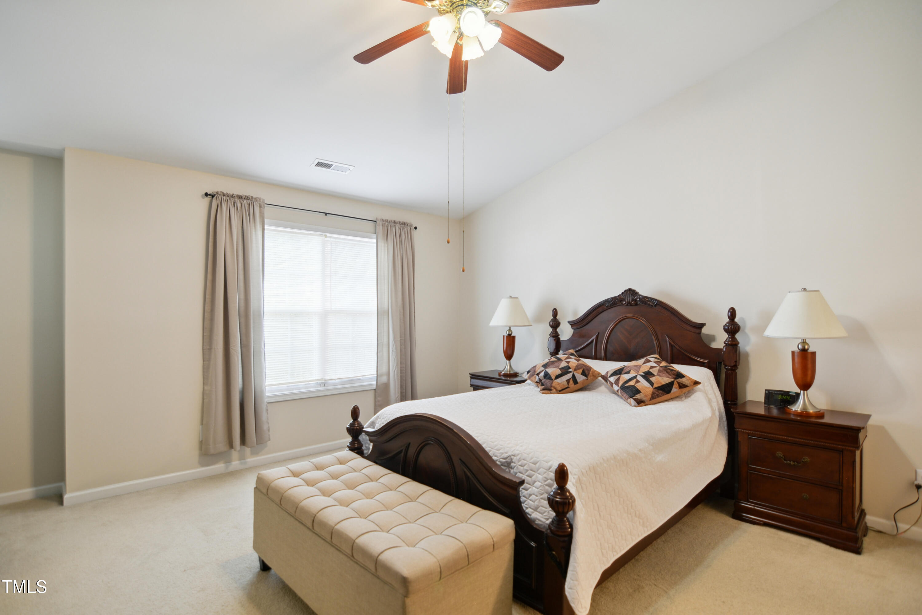 101 Whitney Lane Durham, NC 27713 - Photo 13 of 28 a bedroom with a bed and a chandelier