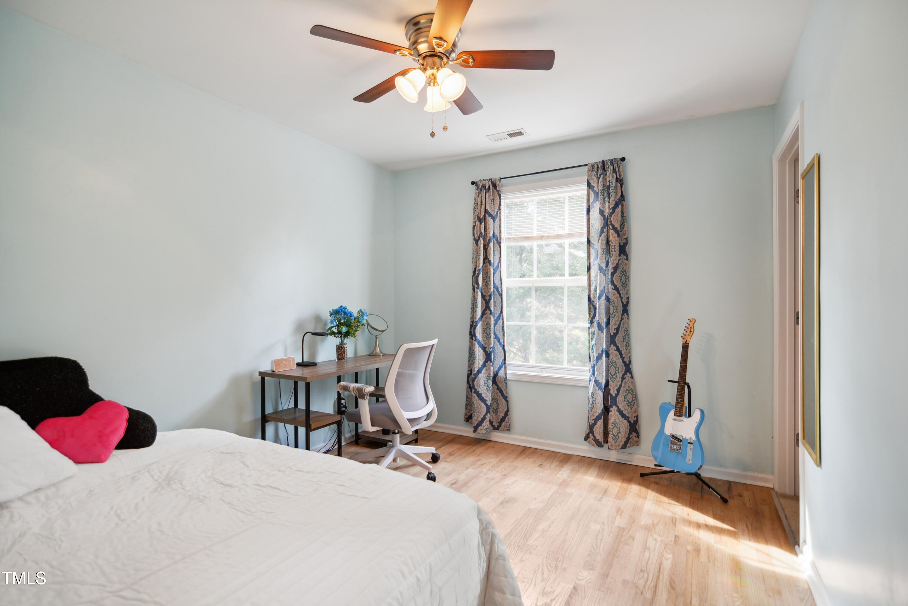 101 Whitney Lane Durham, NC 27713 - Photo 20 of 28 a bedroom with a bed and a chandelier