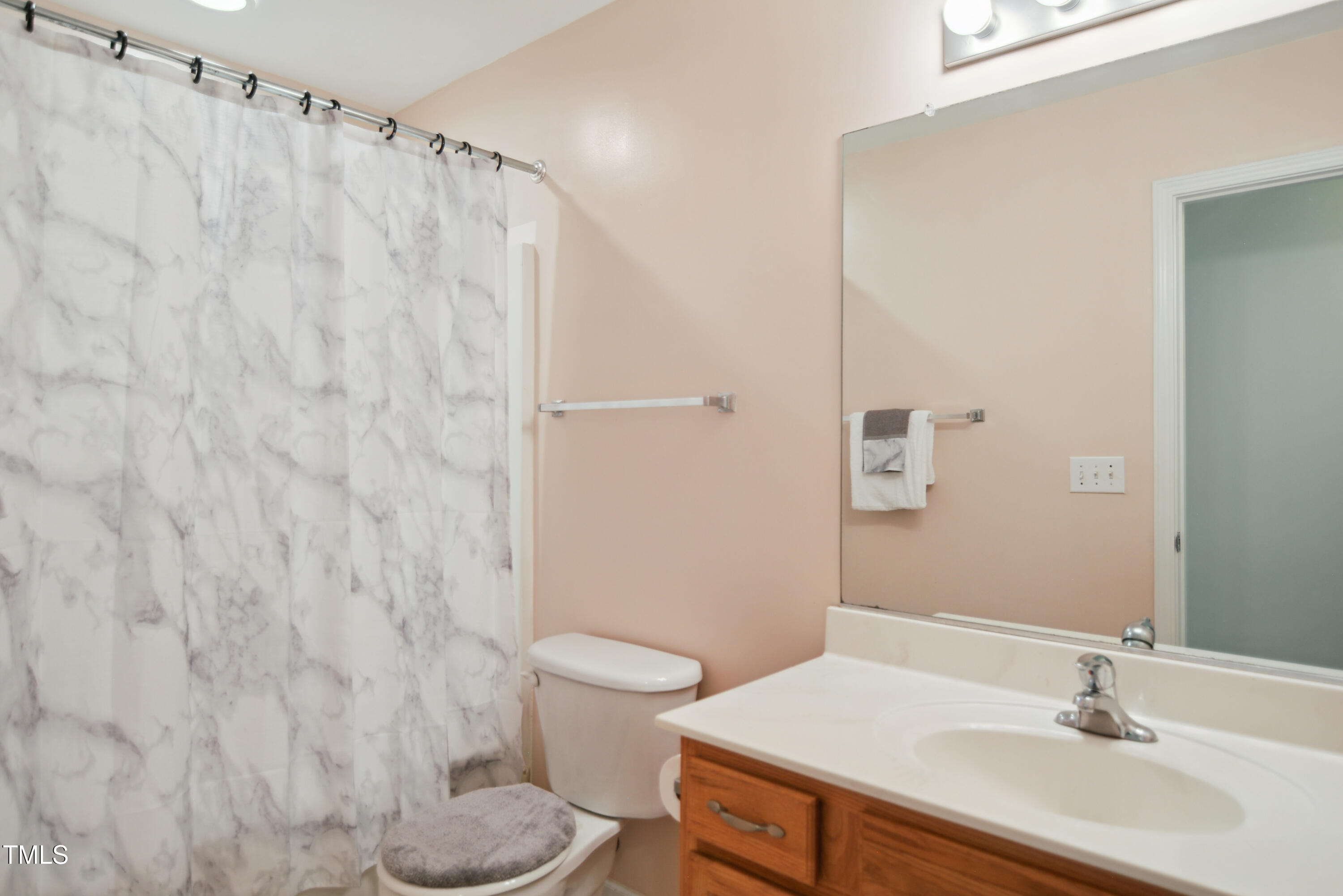 101 Whitney Lane Durham, NC 27713 - Photo 23 of 28 a bathroom with a sink toilet and shower