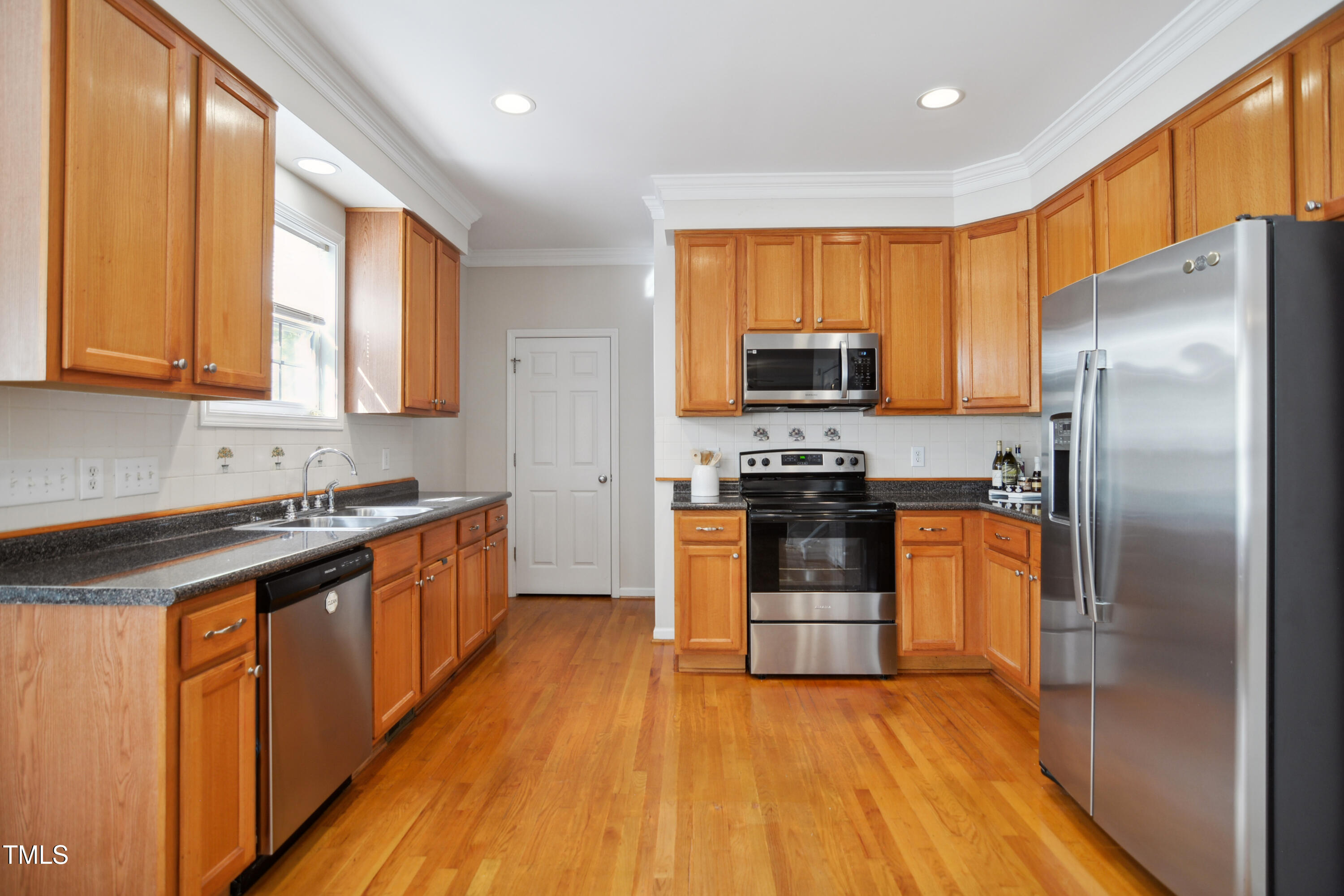 101 Whitney Lane Durham, NC 27713 - Photo 8 of 28 a kitchen with stainless steel appliances a refrigerator sink and microwave
