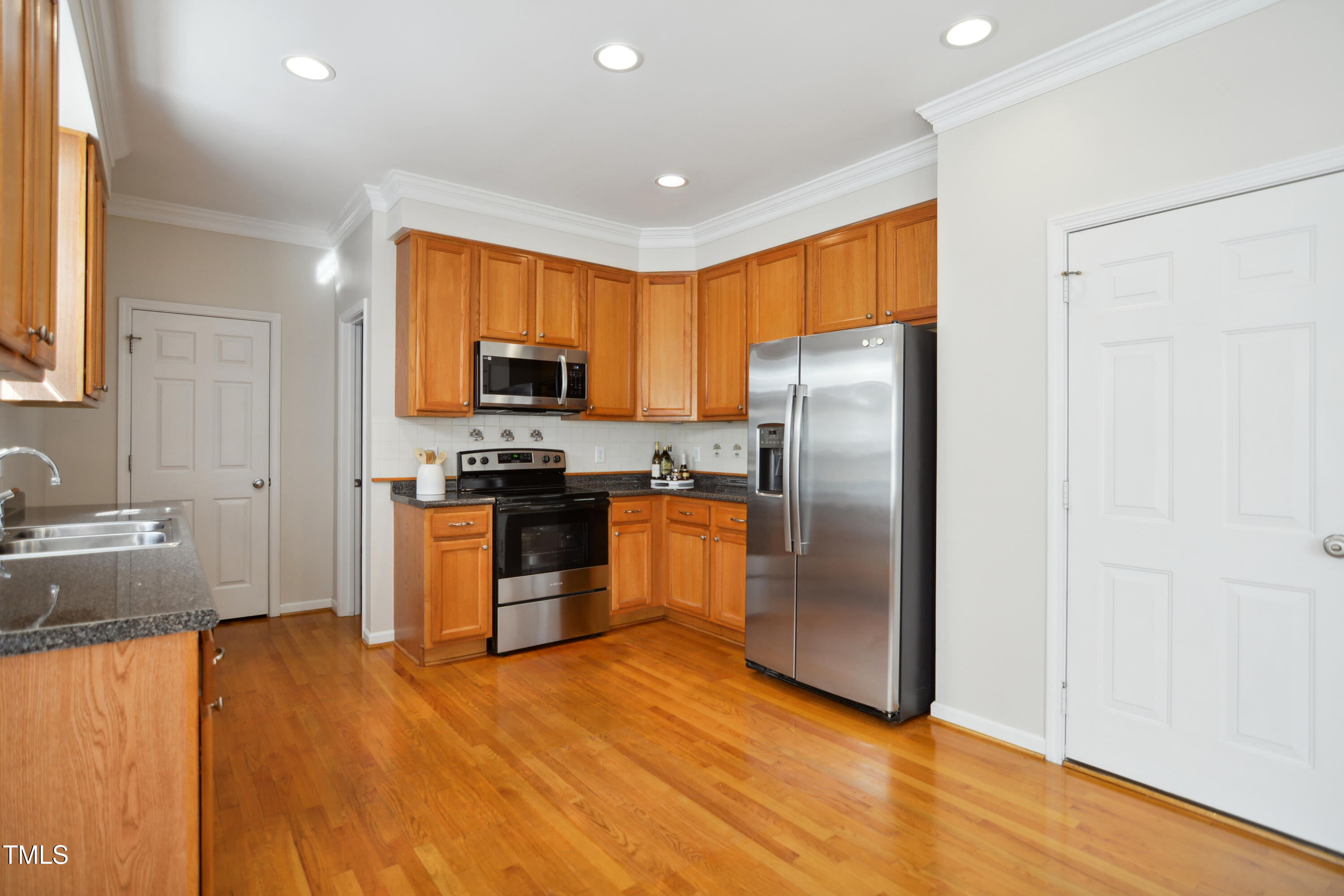 101 Whitney Lane Durham, NC 27713 - Photo 9 of 28 a kitchen with stainless steel appliances granite countertop a refrigerator a stove top oven a sink and dishwasher