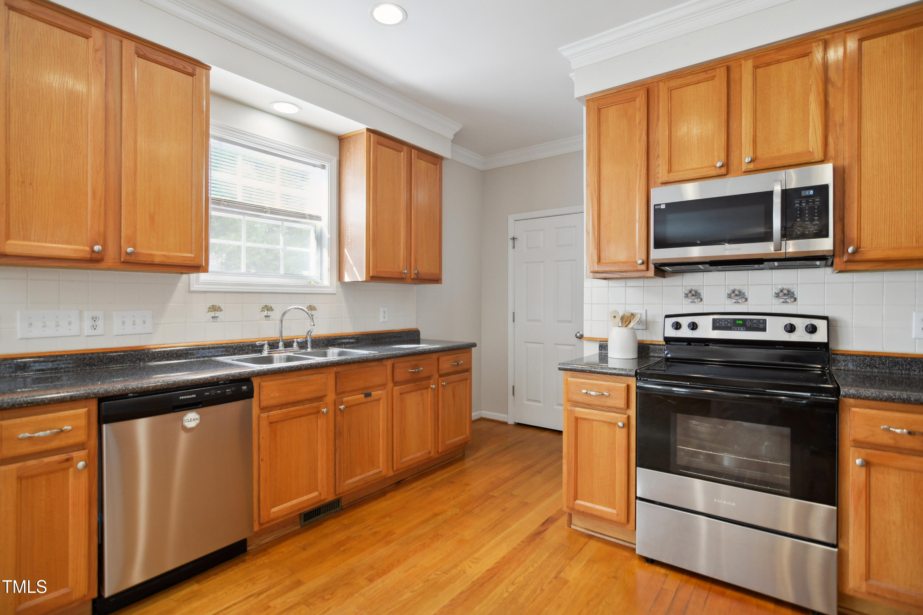 101 Whitney Lane Durham, NC 27713 - Photo 10 of 28 a kitchen with stainless steel appliances granite countertop a stove microwave and sink
