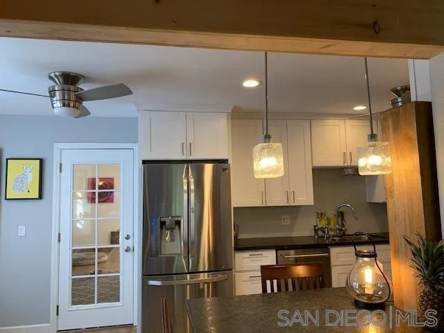 10411 Don Pico Road Spring Valley, CA 91978 - Photo 3 of 3 a kitchen with refrigerator a stove and a chandelier