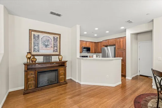 a view of a kitchen with furniture and wooden floor