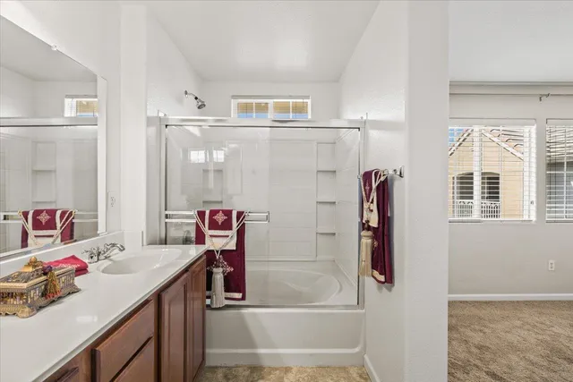 a bathroom with a sink mirror and a bath tub