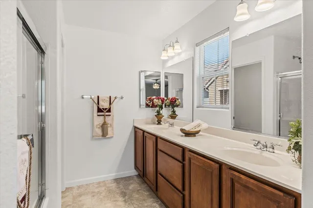 a bathroom with a sink vanity granite and a mirror