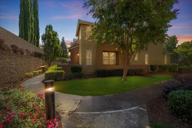 a front view of a house with garden