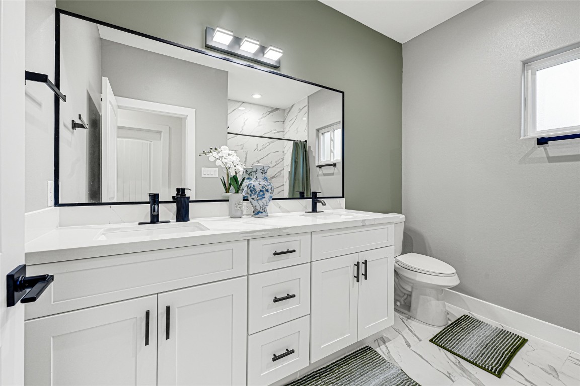 3510 Rebecca Street Houston, TX 77021 - Photo 20 of 28 a bathroom with a double vanity sink and a mirror