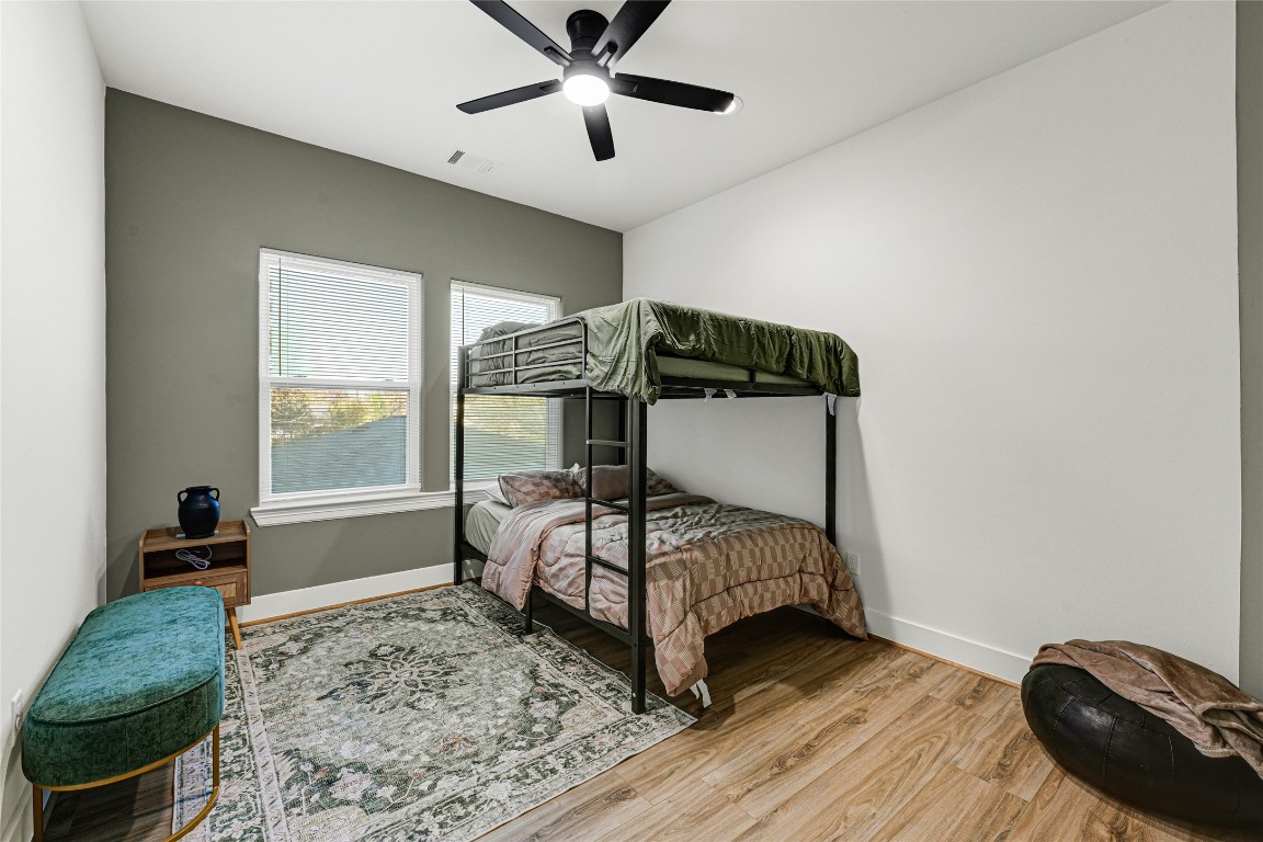 3510 Rebecca Street Houston, TX 77021 - Photo 24 of 28 a bedroom with a bed and wooden floor
