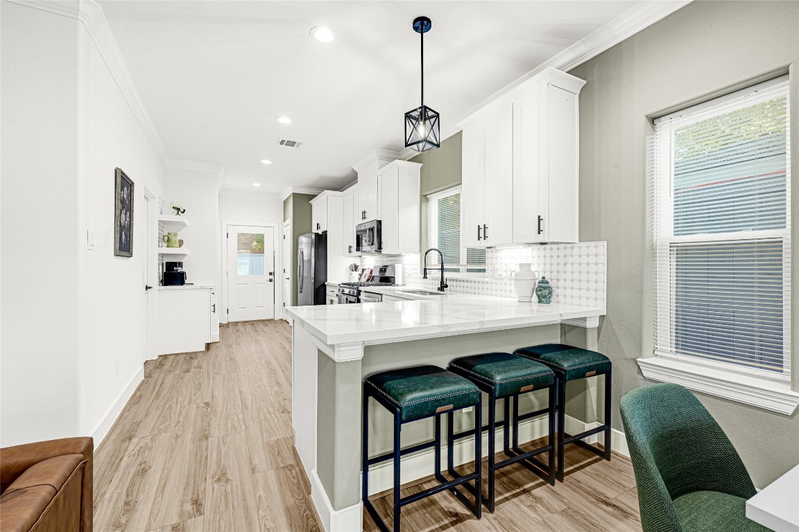 3510 Rebecca Street Houston, TX 77021 - Photo 4 of 28 a view of dining table chairs wooden floor and kitchen view