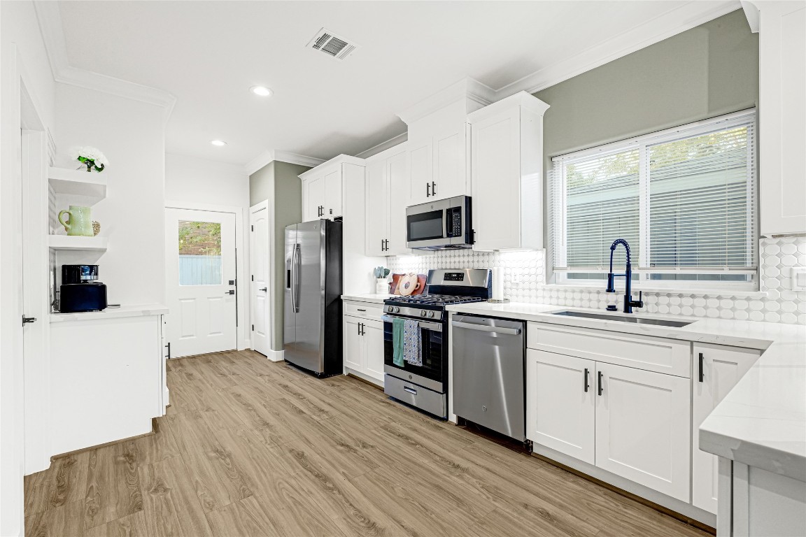 3510 Rebecca Street Houston, TX 77021 - Photo 5 of 28 a kitchen with kitchen island granite countertop a sink cabinets and stainless steel appliances