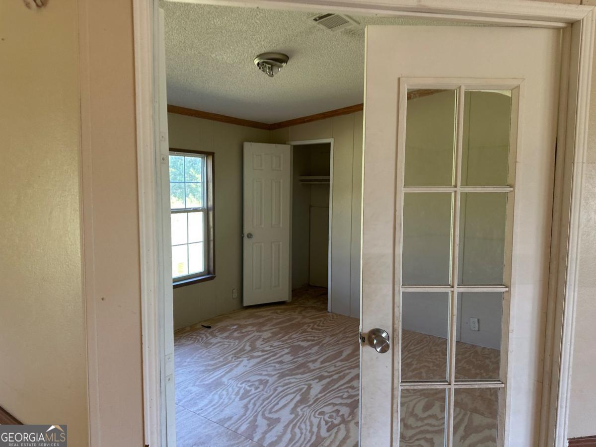 642 Still Road Alamo, GA 30411 - Photo 13 of 21 a view of an empty room with wooden floor and a window