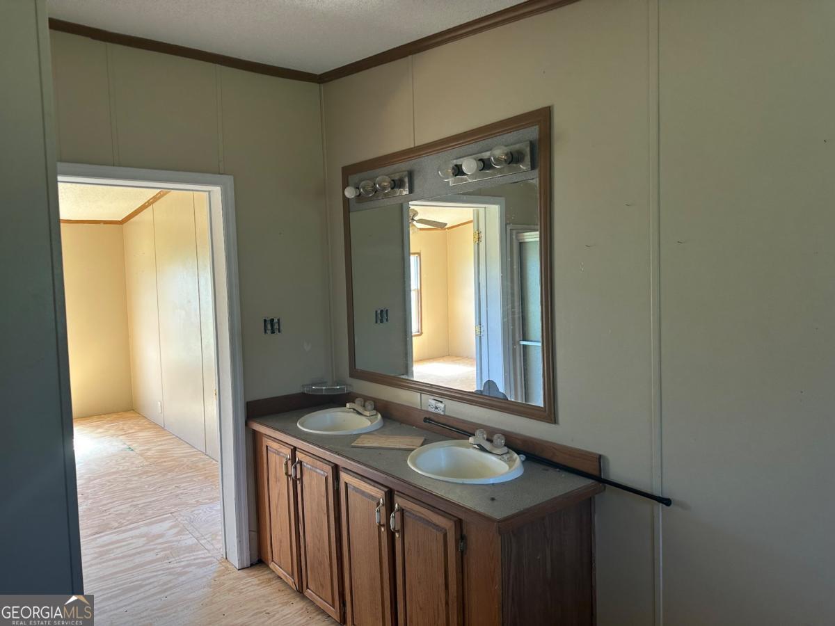 642 Still Road Alamo, GA 30411 - Photo 14 of 21 a bathroom with a sink and a mirror