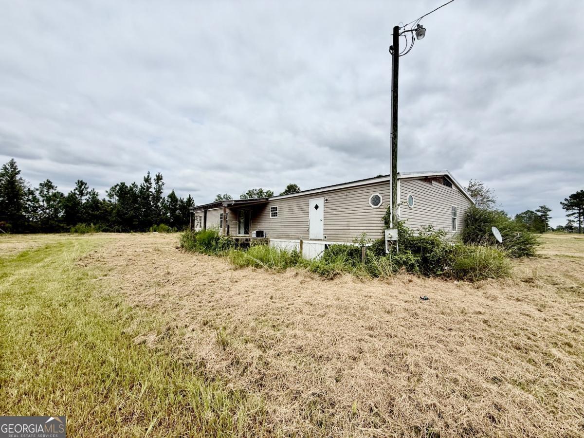 642 Still Road Alamo, GA 30411 - Photo 19 of 21 a front view of a house with a yard and lake view
