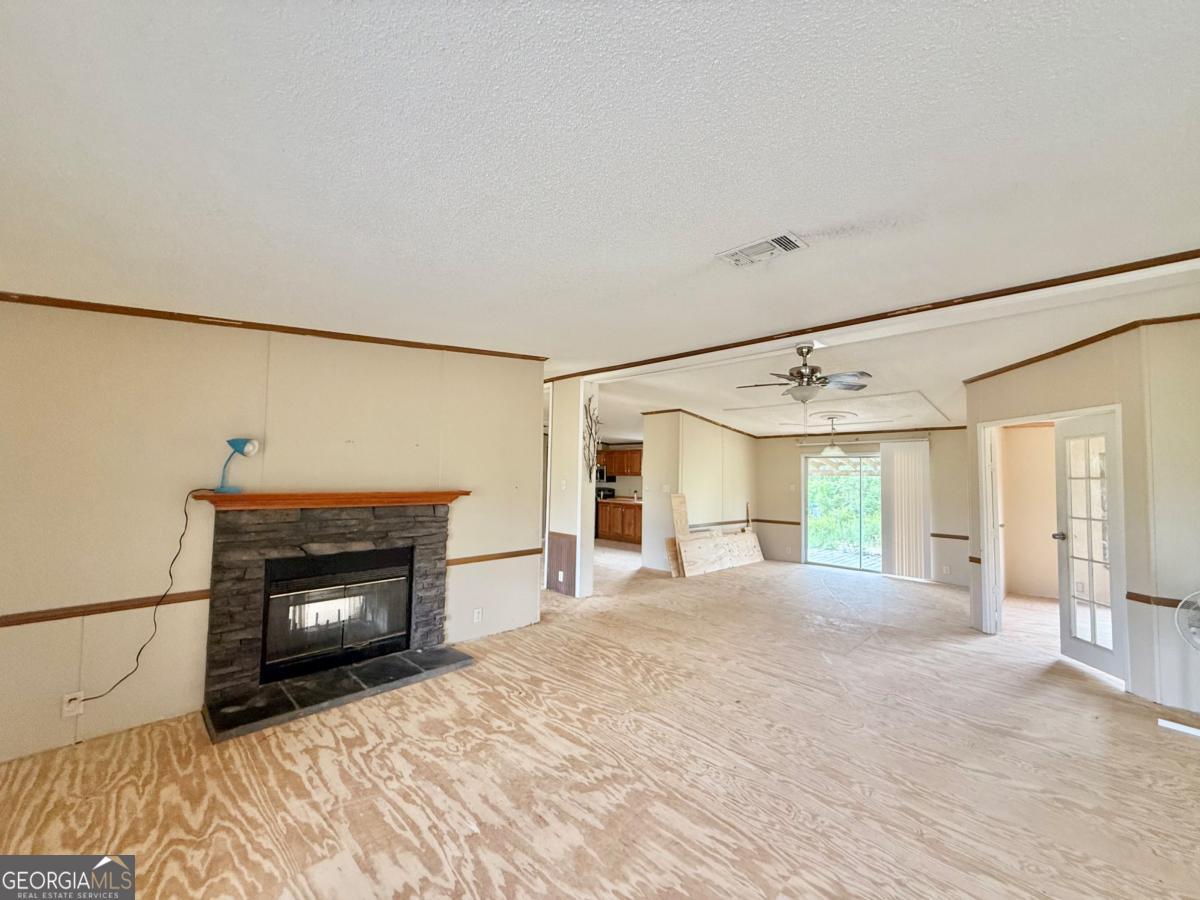 642 Still Road Alamo, GA 30411 - Photo 2 of 21 a view of a livingroom with a fireplace and window