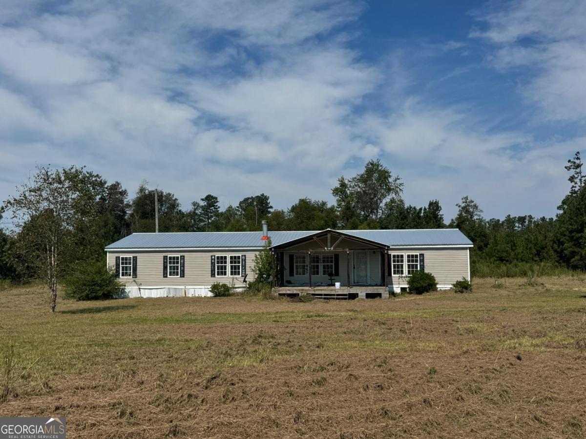 642 Still Road Alamo, GA 30411 - Photo 21 of 21 a front view of house with yard and trees around