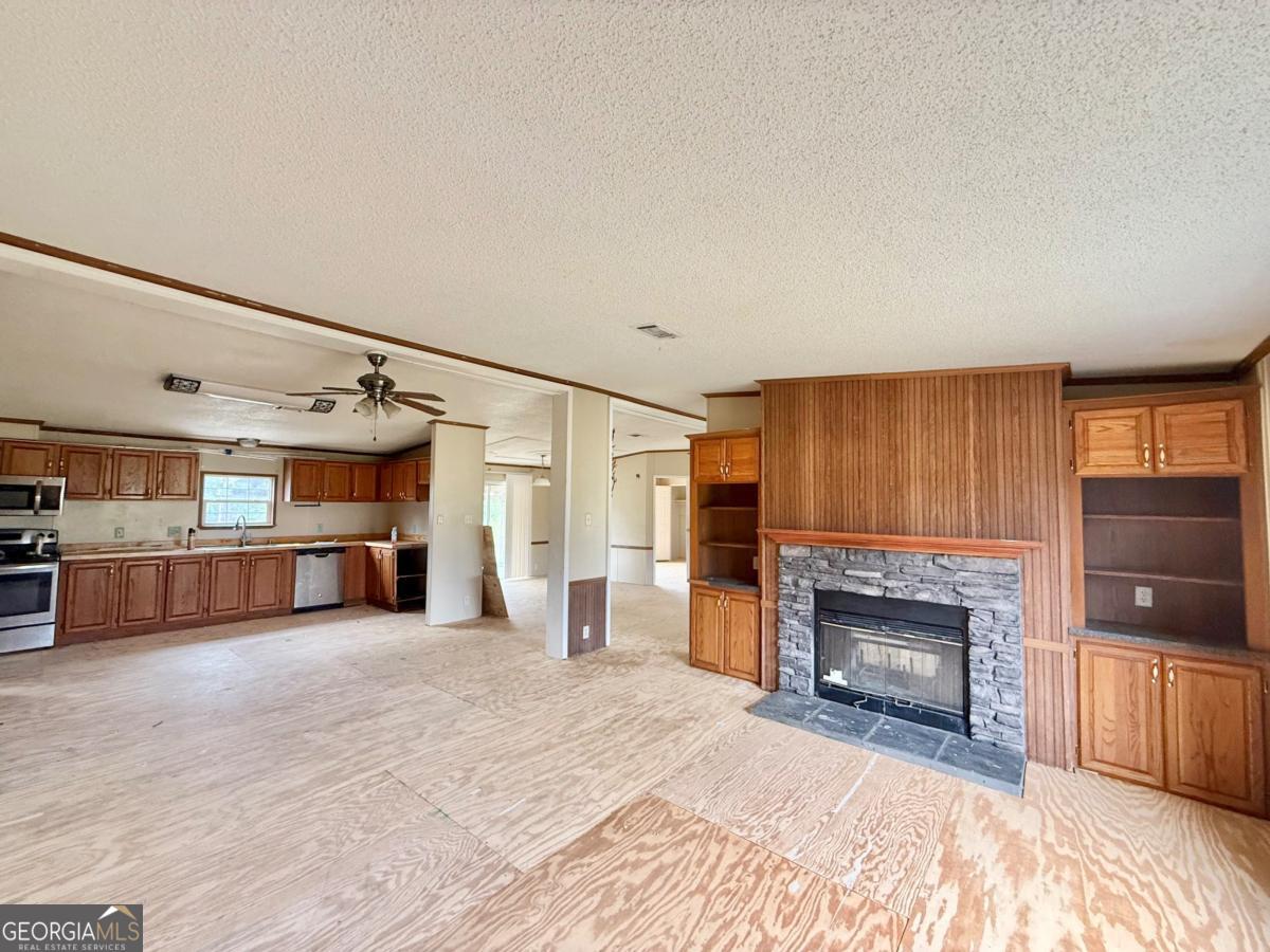 642 Still Road Alamo, GA 30411 - Photo 3 of 21 a view of a livingroom with an empty space and a fireplace