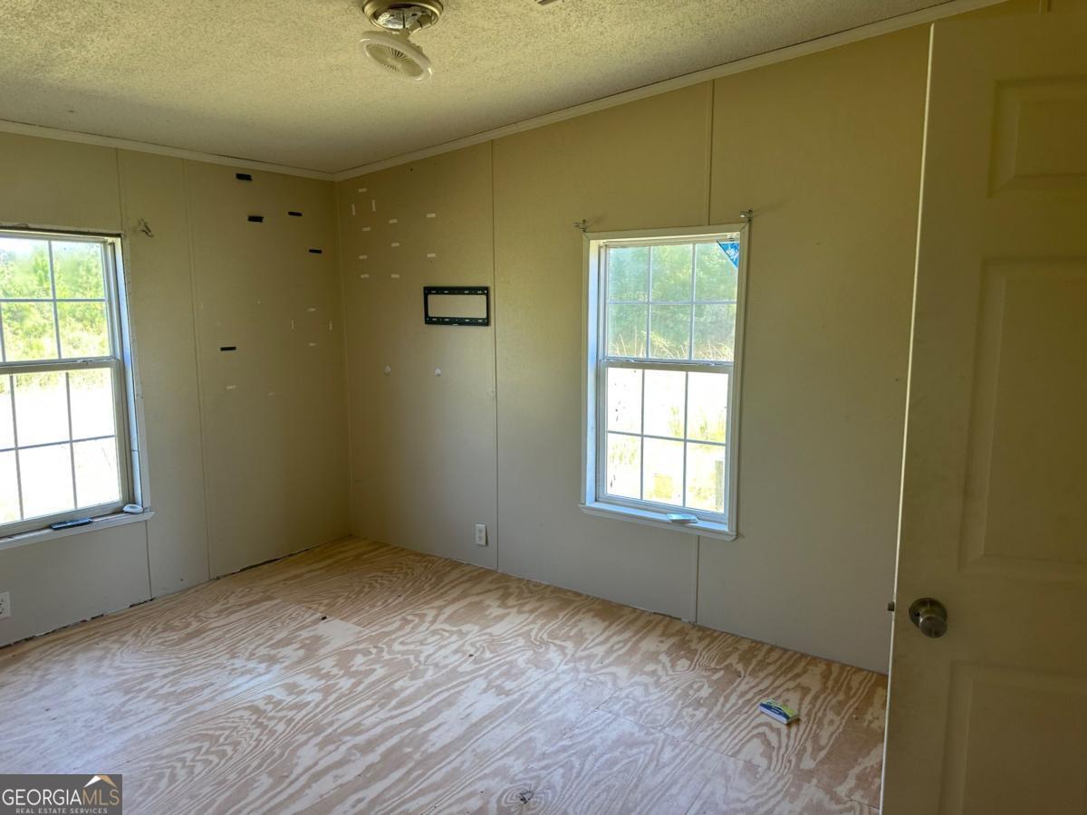 642 Still Road Alamo, GA 30411 - Photo 9 of 21 a view of an empty room with a window