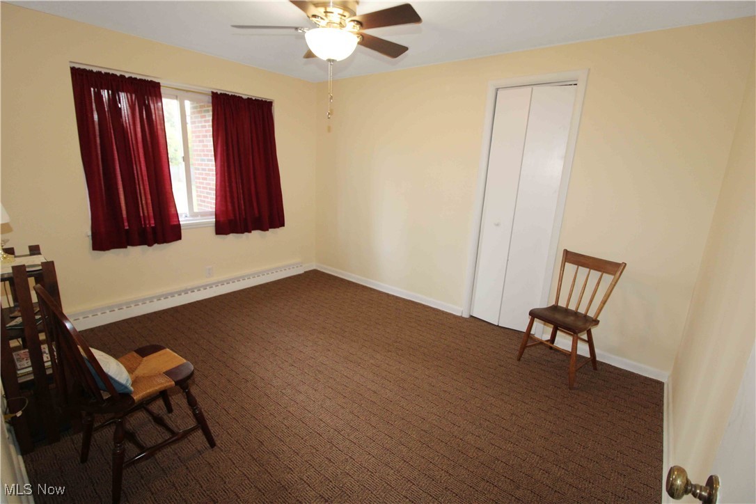 2708 East Sand Road Port Clinton, OH 43452 - Photo 25 of 33 Sitting room featuring a baseboard radiator, dark carpet, and ceiling fan