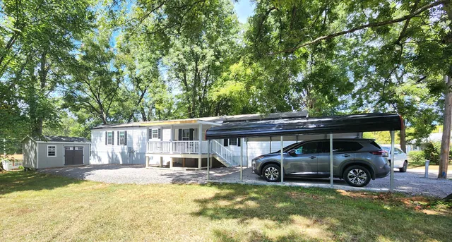 a view of a house with swimming pool and sitting area