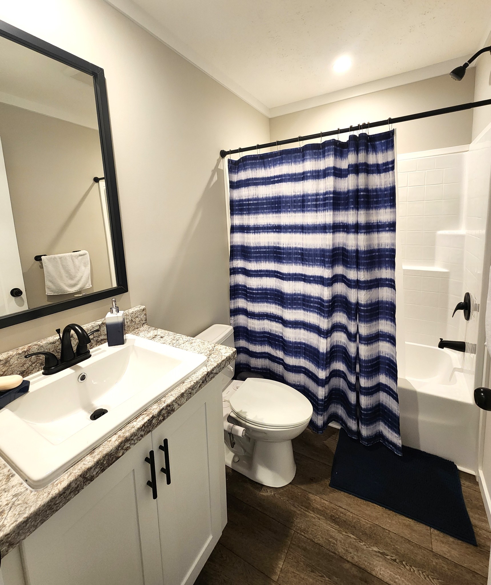 23 Yates Street Paris, TN 38242 - Photo 11 of 17 a bathroom with a sink toilet a mirror and vanity