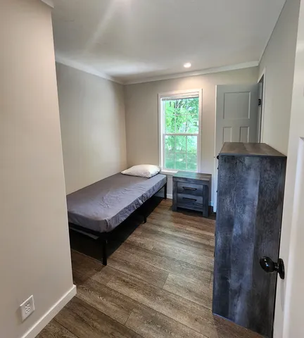 a bedroom with a bed and a window