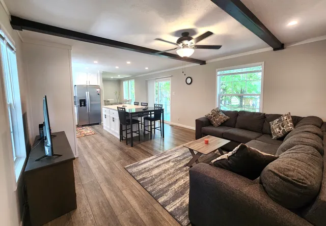 a living room with furniture and a large window