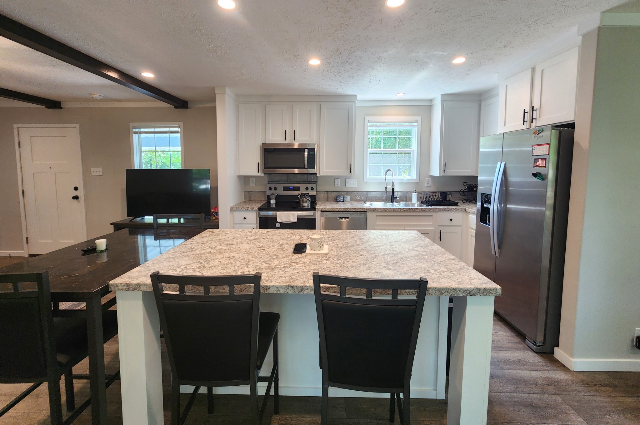 23 Yates Street Paris, TN 38242 - Photo 5 of 17 a kitchen with stainless steel appliances granite countertop a table chairs refrigerator and microwave