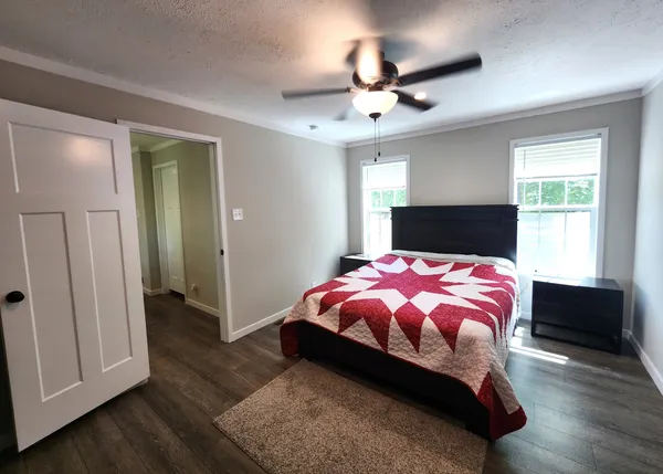 a bedroom with a bed and a chandelier