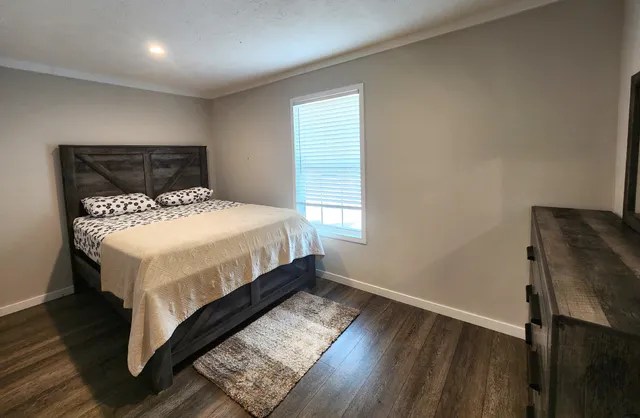 a bed sitting in a bedroom next to a window