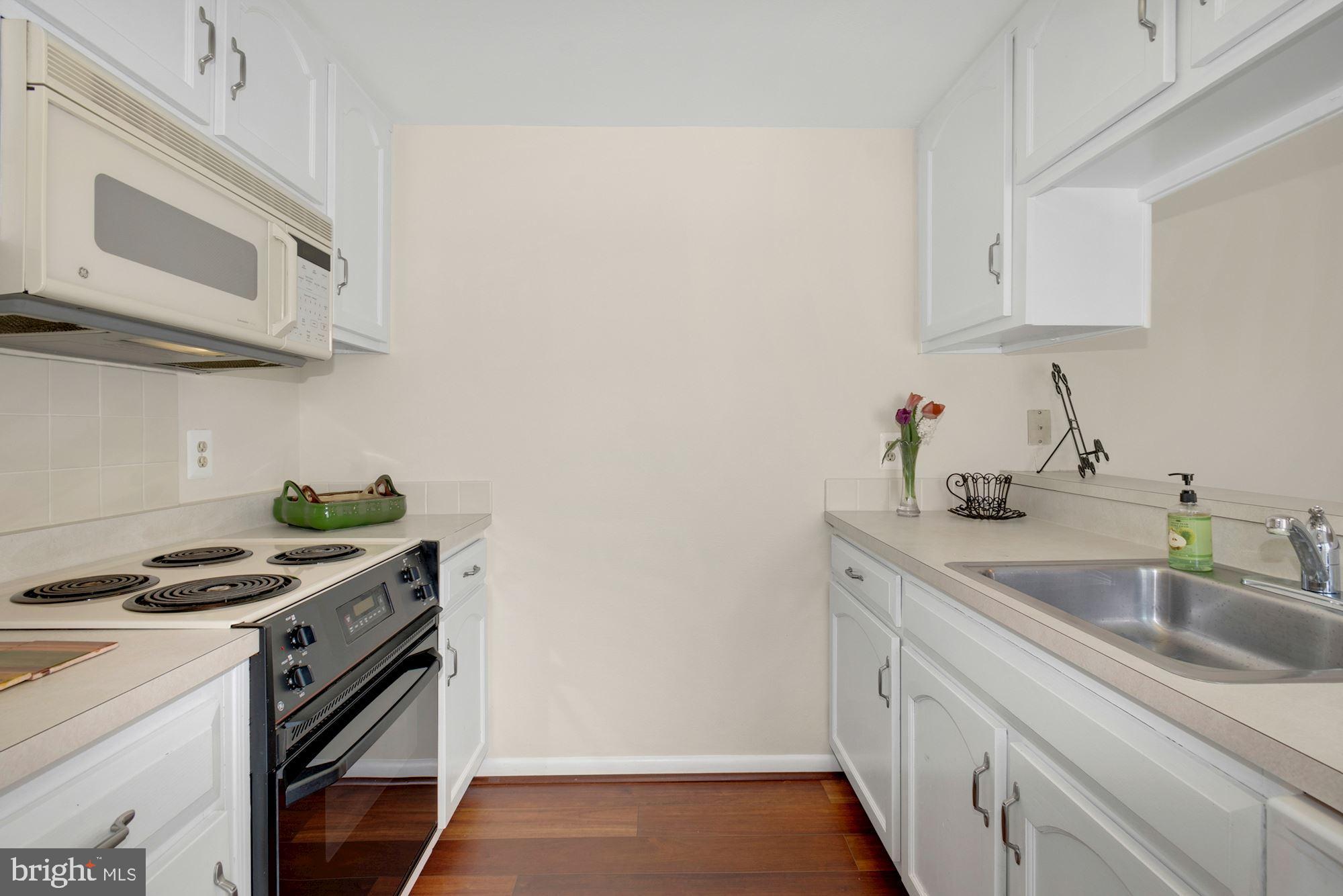 3568 Fiske Terrace, Unit 144B Silver Spring, MD 20906 - Photo 5 of 35 Kitchen & breakfast bar, sliding glass door to pat