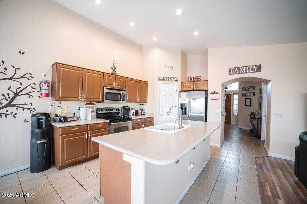 3569 East Utopia Road Phoenix, AZ 85050 - Photo 2 of 16 a kitchen with stainless steel appliances a stove refrigerator sink and cabinets