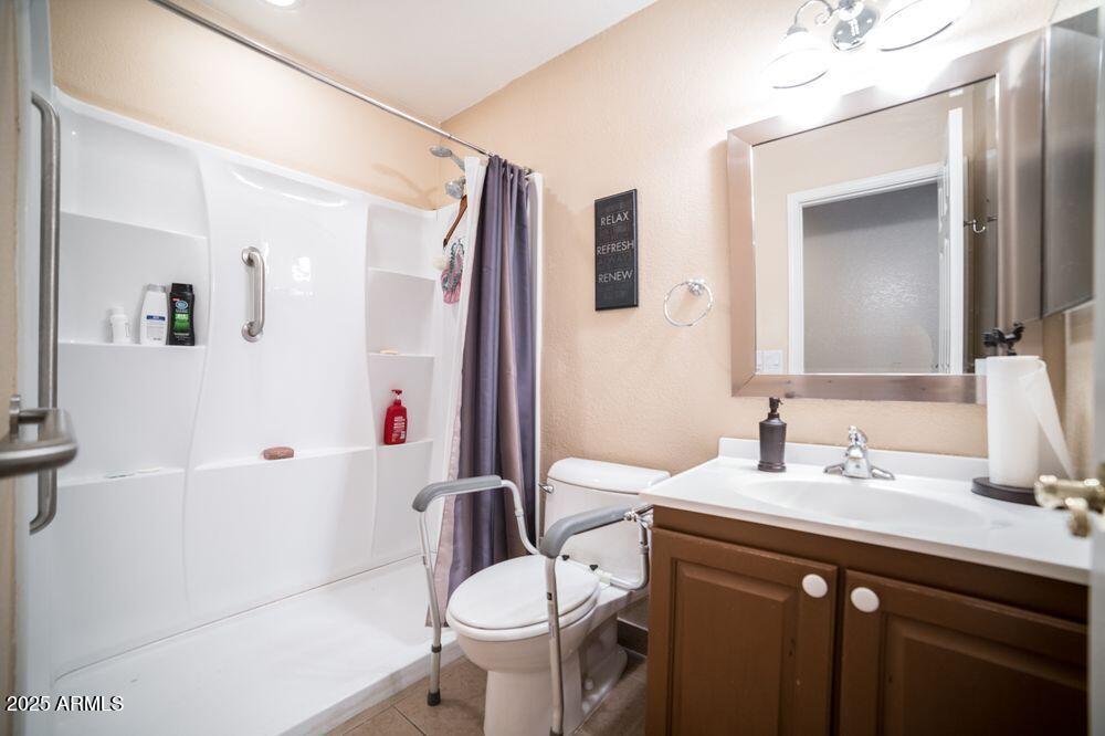 3569 East Utopia Road Phoenix, AZ 85050 - Photo 6 of 16 a bathroom with a sink toilet and shower