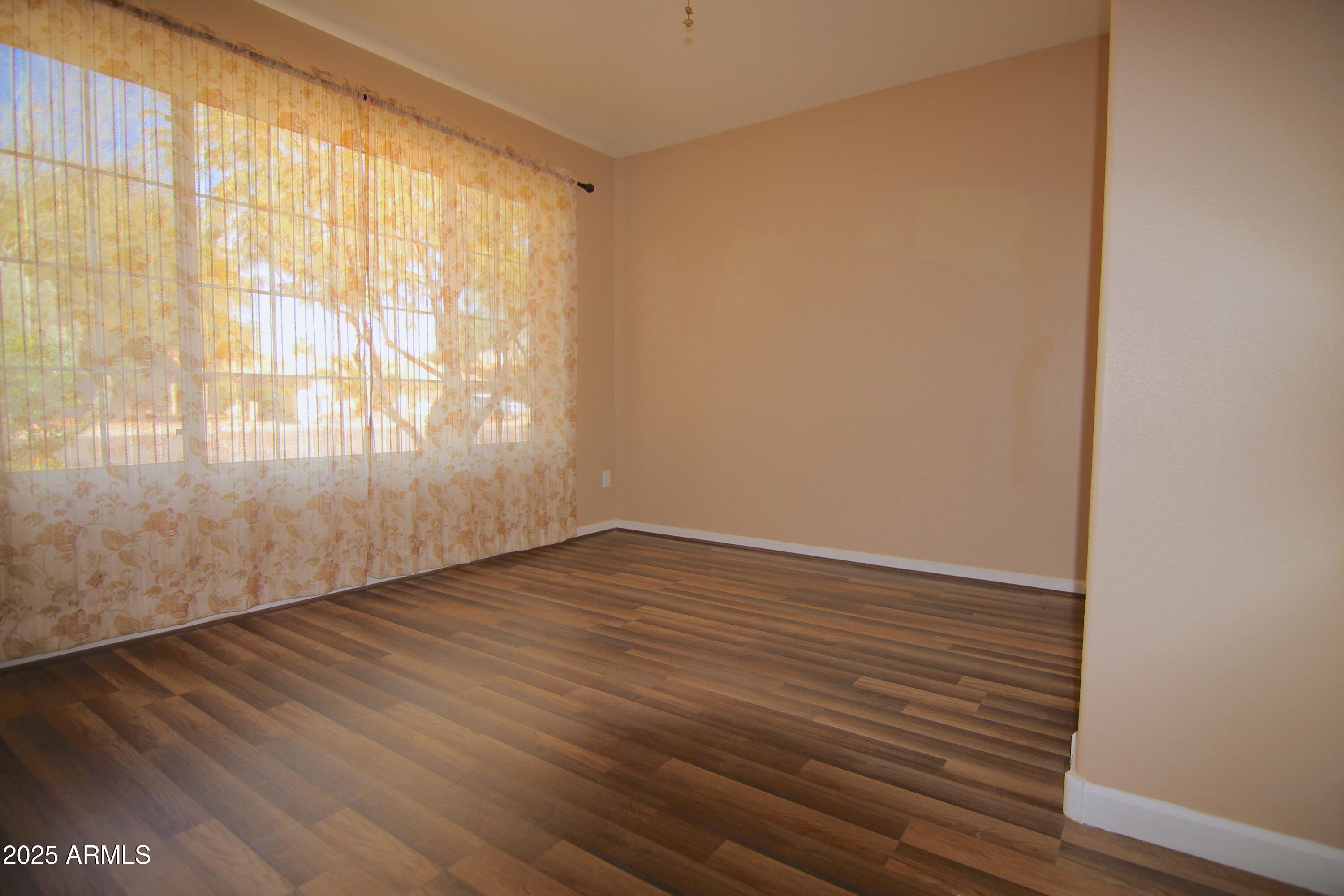 3569 East Utopia Road Phoenix, AZ 85050 - Photo 7 of 16 wooden floor in an empty room with a window