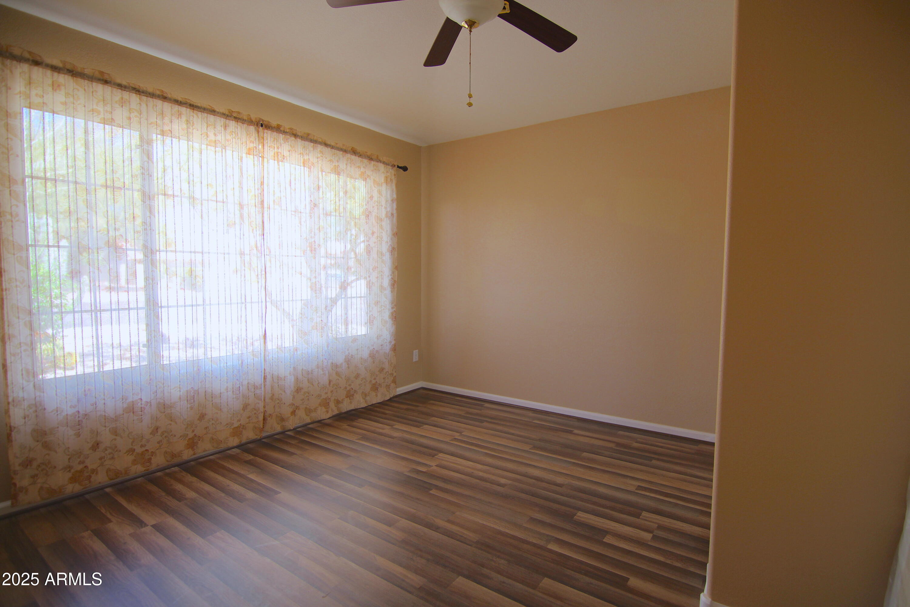3569 East Utopia Road Phoenix, AZ 85050 - Photo 9 of 16 wooden floor in an empty room with a window