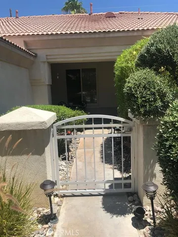 a view of a house with a yard and sitting area