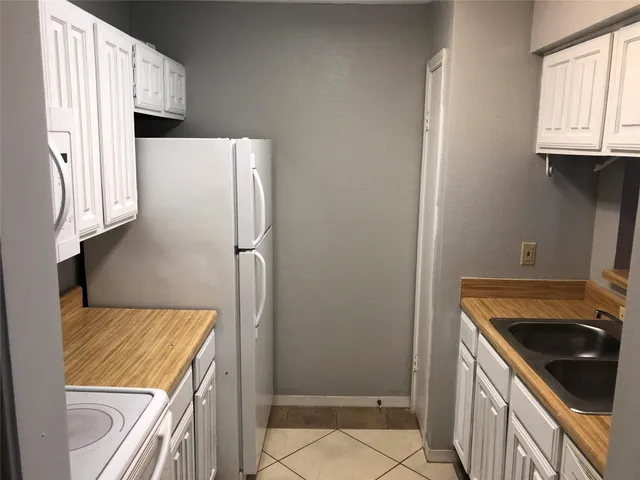 a kitchen with a refrigerator sink and stove