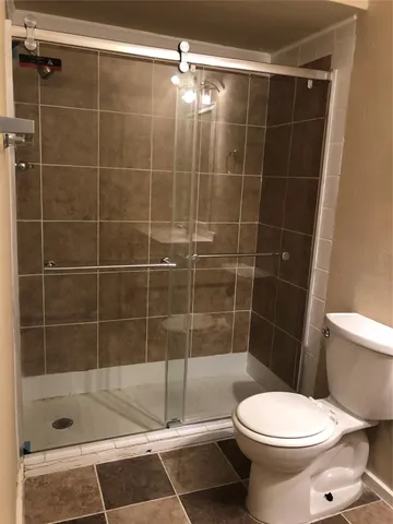 a bathroom with a toilet and shower