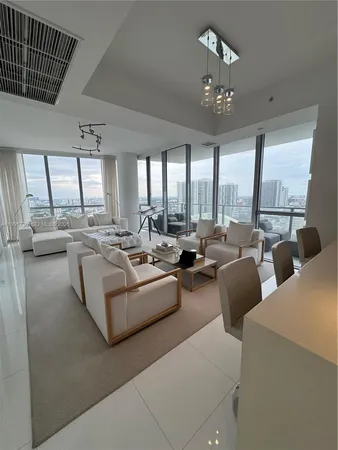a kitchen with stainless steel appliances kitchen island granite countertop a refrigerator and a sink