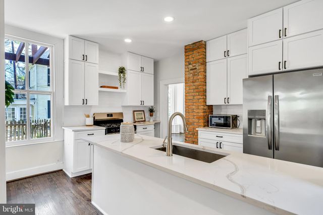 a kitchen with a stove top oven and cabinets