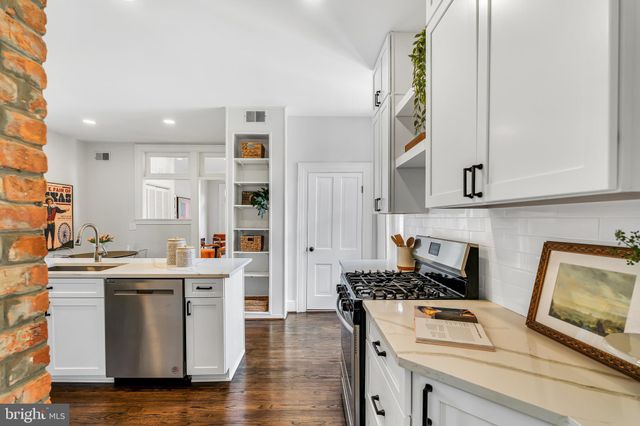 a kitchen with stainless steel appliances granite countertop a stove and a refrigerator