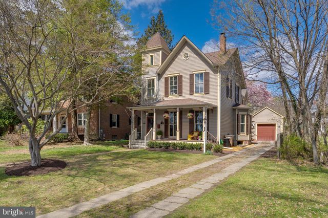 a front view of a building with trees and trees