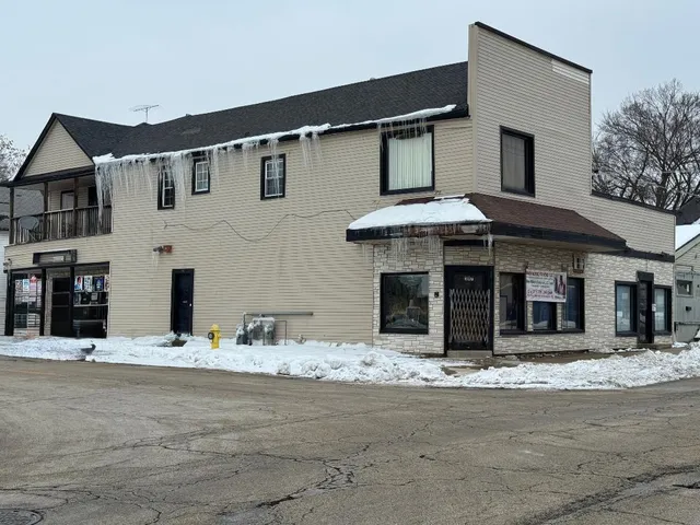 a view of a white house with large windows
