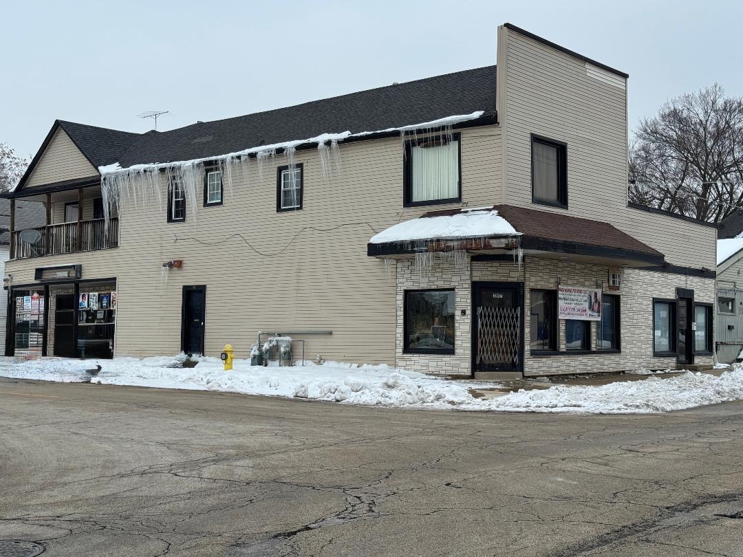 a view of a white house with large windows