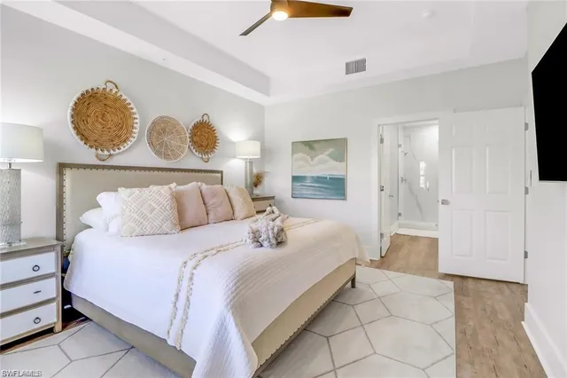 a bedroom with a bed and flat screen tv