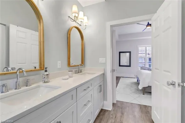a spacious bathroom with a double vanity sink a mirror and a shower