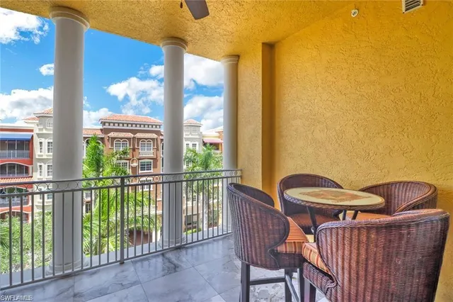 a view of a chair and table in the balcony