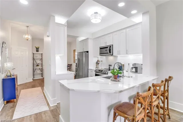 a dining room with furniture and a kitchen view