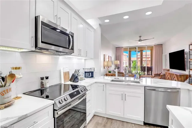 a kitchen with a sink stove and microwave