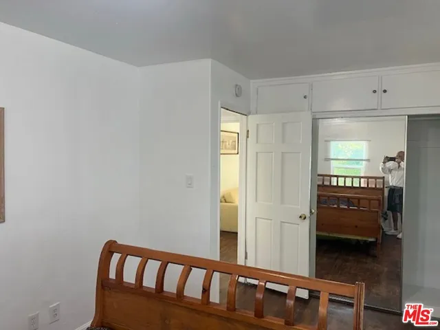 a view of a hallway with wooden floor and windows